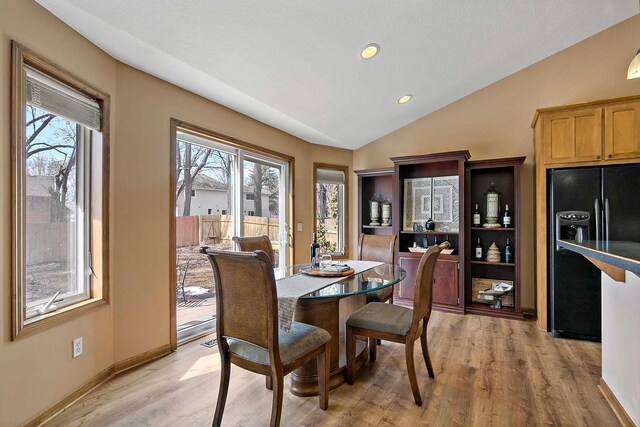 dining area featuring recessed lighting, light wood-type flooring, lofted ceiling, and baseboards