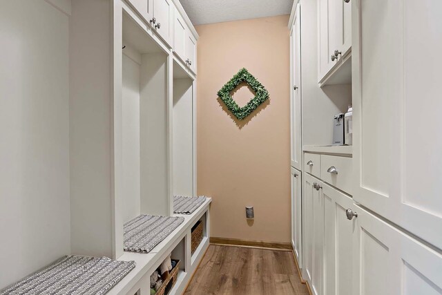 mudroom featuring light wood-type flooring and baseboards