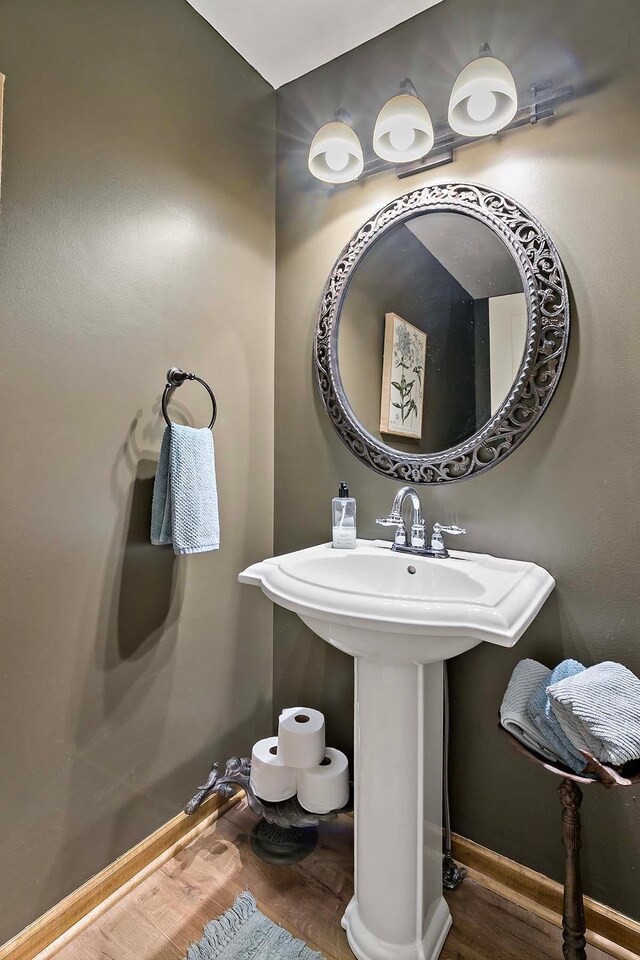 bathroom featuring baseboards and wood finished floors