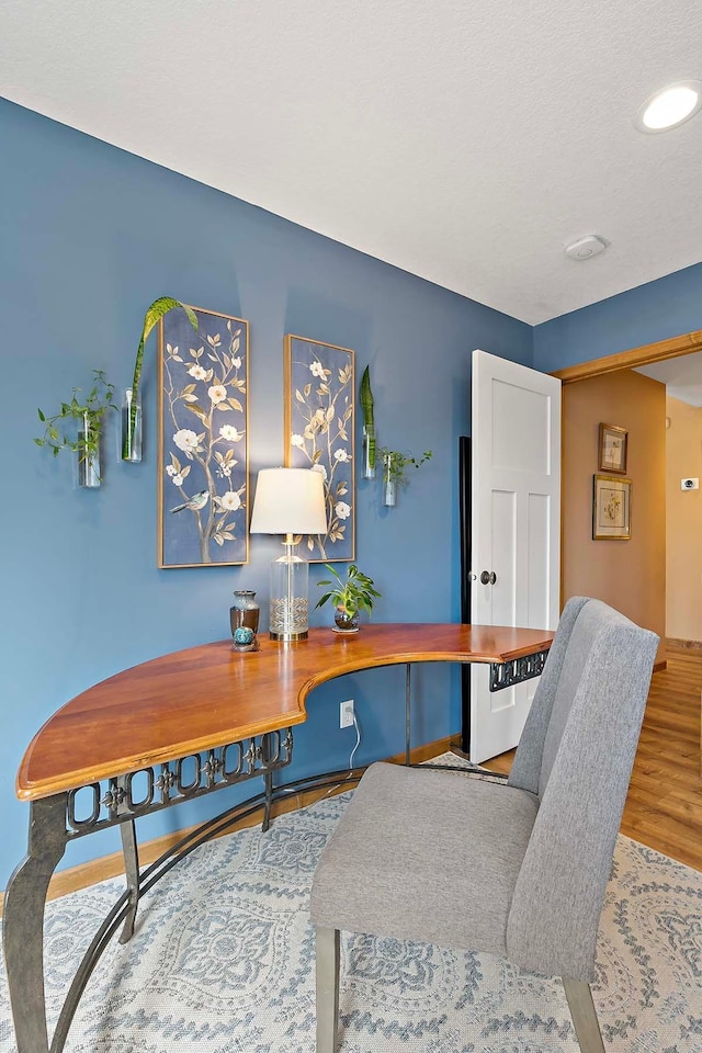 home office with wood finished floors