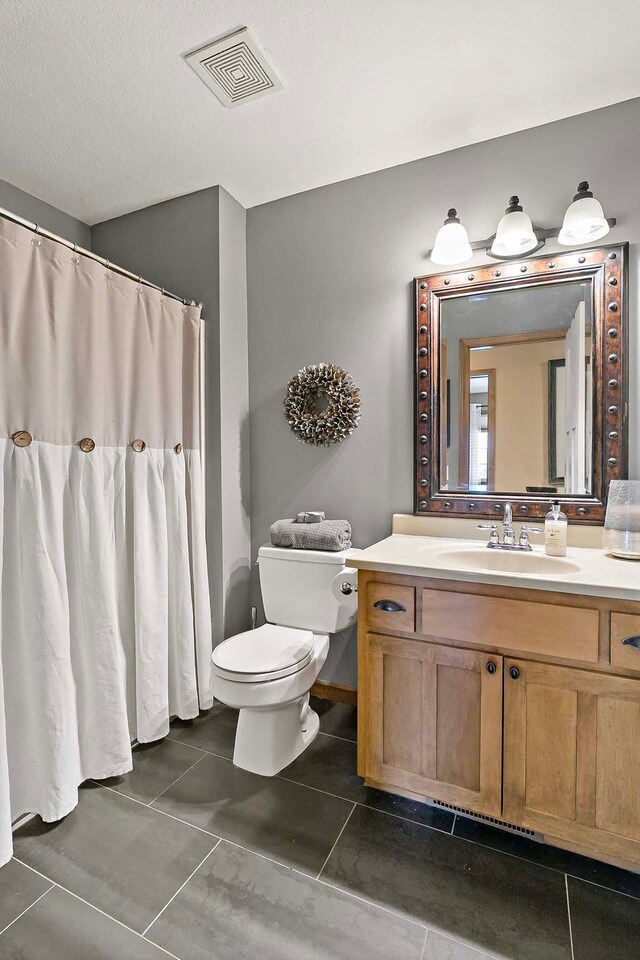 bathroom featuring tile patterned flooring, visible vents, toilet, a shower with curtain, and vanity