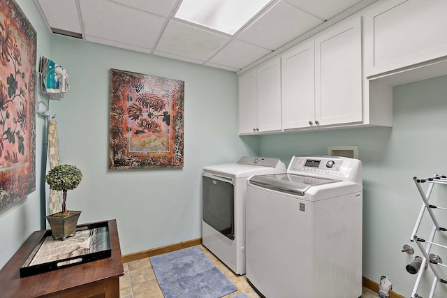 laundry area with baseboards, cabinet space, and washer and clothes dryer