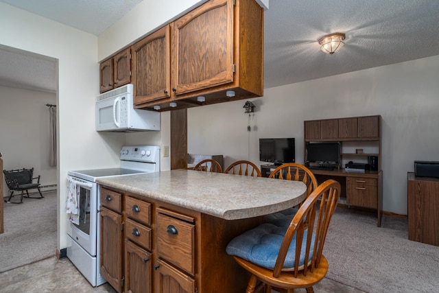 kitchen with light carpet, white appliances, a breakfast bar, light countertops, and a textured ceiling