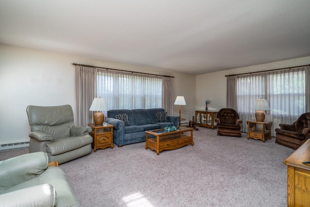 living area with a baseboard heating unit and carpet