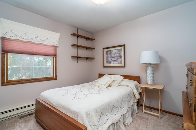 carpeted bedroom featuring a baseboard radiator and baseboards