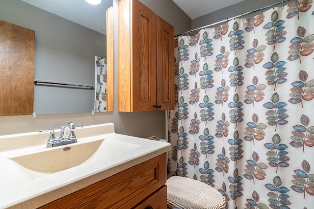 bathroom featuring vanity and a shower with shower curtain