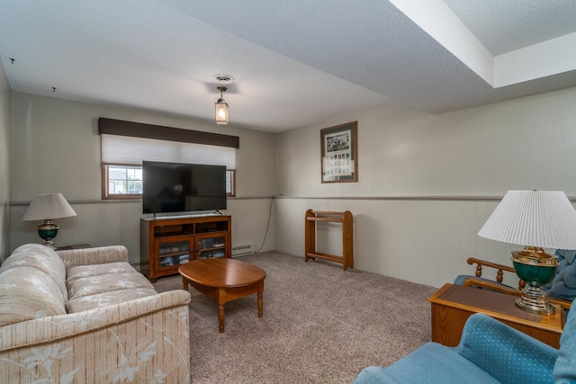 living area with a wainscoted wall, carpet flooring, a textured ceiling, and baseboard heating