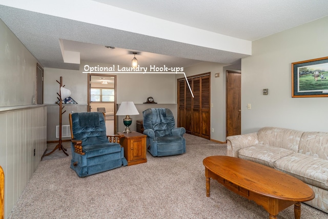 living area with light carpet, a textured ceiling, and visible vents