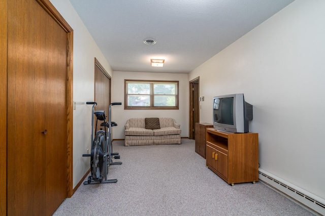 workout room featuring light carpet, a baseboard radiator, visible vents, and baseboards