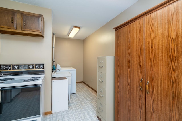 washroom with laundry area, washing machine and dryer, baseboards, and light floors