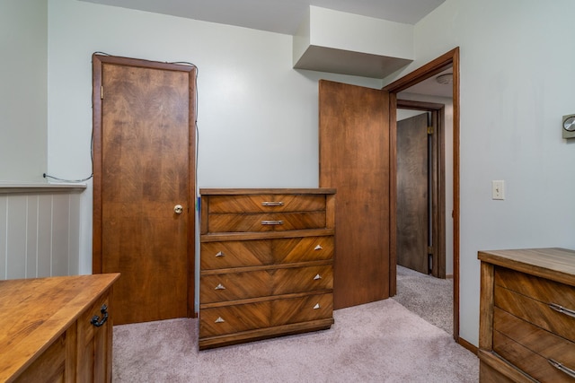 bedroom featuring light carpet