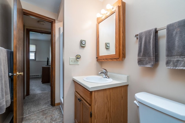 full bath featuring a baseboard heating unit, vanity, toilet, and a shower stall