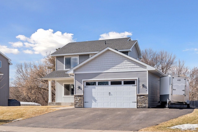 view of front of property with a garage, a shingled roof, driveway, stone siding, and board and batten siding