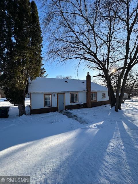 single story home featuring a chimney