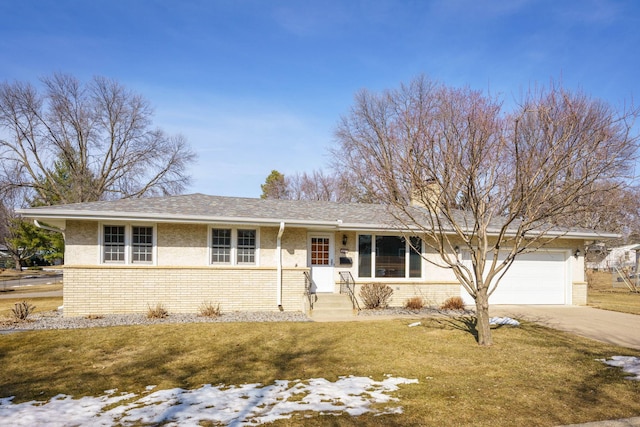 ranch-style house with concrete driveway, an attached garage, brick siding, and a front lawn