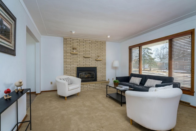 living room with light colored carpet, a fireplace, crown molding, and baseboards