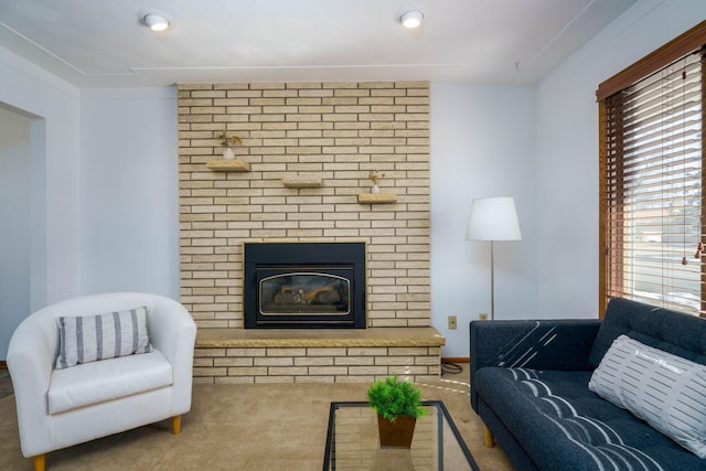 carpeted living room with a brick fireplace