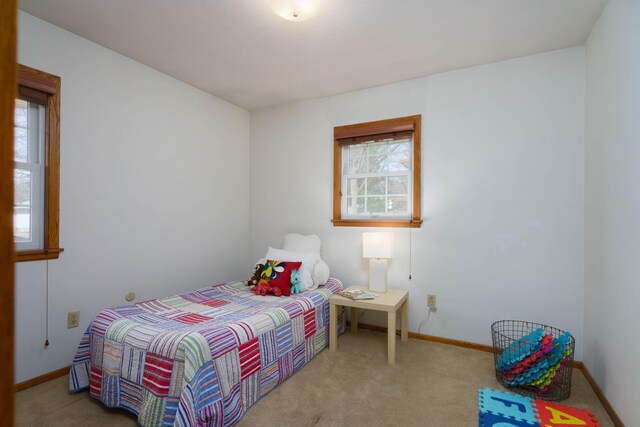 carpeted bedroom with baseboards