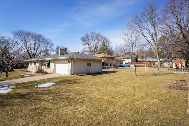 exterior space with a lawn, fence, concrete driveway, an attached garage, and a chimney