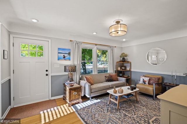 living area featuring baseboards, wood finished floors, and recessed lighting