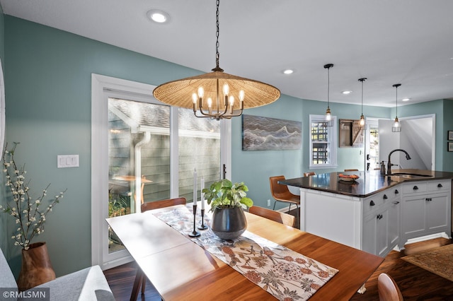 dining area with a chandelier, dark wood-style flooring, and recessed lighting