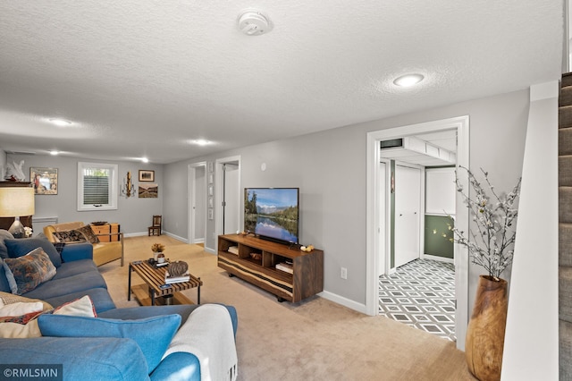 living room with light colored carpet, a textured ceiling, baseboards, and stairs