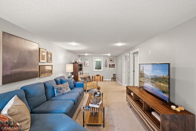 living area with light carpet, a textured ceiling, and baseboards