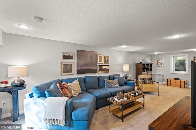 living room with a textured ceiling, baseboards, and light colored carpet