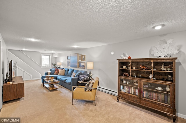 living area with carpet floors, stairway, a baseboard heating unit, and a textured ceiling