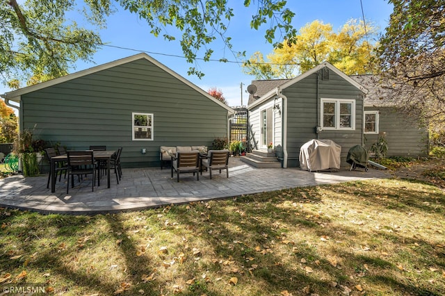 rear view of house featuring entry steps, a patio, a yard, and an outdoor hangout area