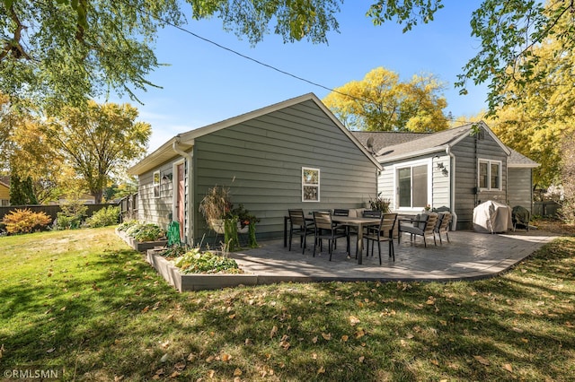 back of property featuring a patio, fence, and a lawn