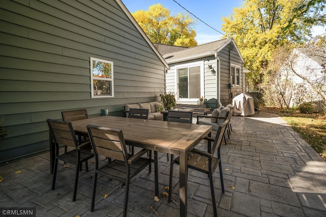 view of patio / terrace with outdoor dining space, a grill, and an outdoor structure