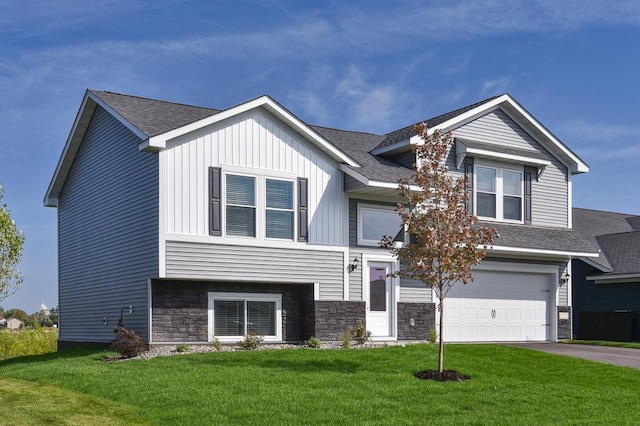 view of front facade featuring driveway, an attached garage, a front lawn, and a shingled roof