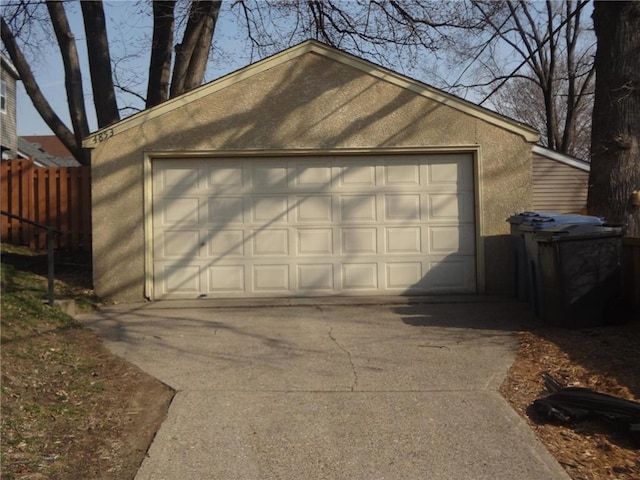 detached garage featuring fence