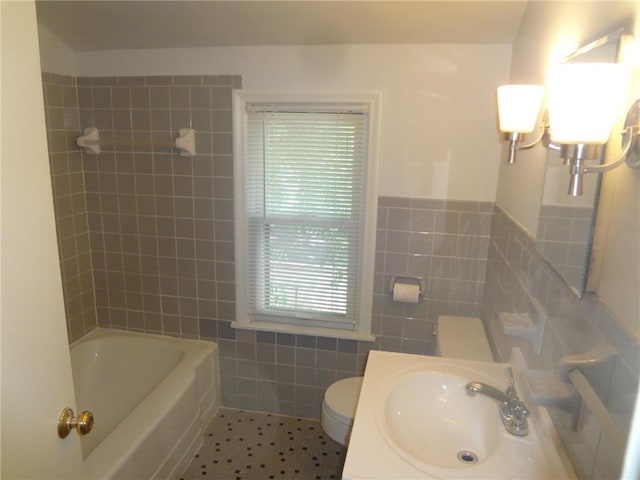 full bath with tile patterned flooring, toilet, vanity, tile walls, and water heater