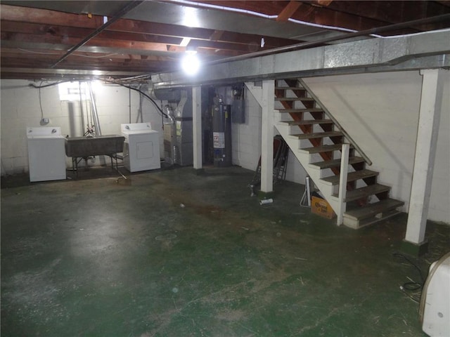 unfinished below grade area featuring washer / clothes dryer, electric water heater, a sink, and stairway