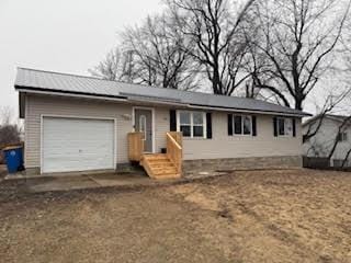 ranch-style house with a garage and driveway