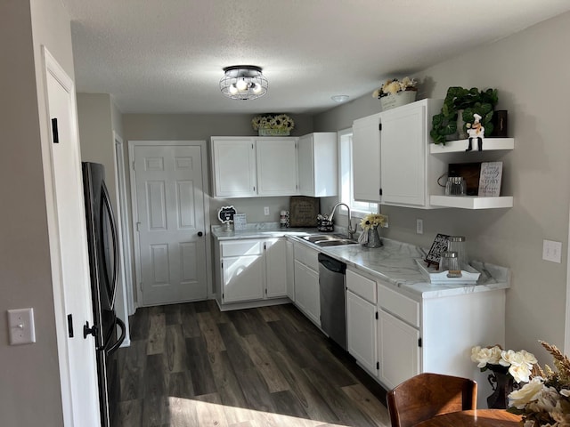 kitchen featuring dark wood-type flooring, light countertops, white cabinets, and dishwasher