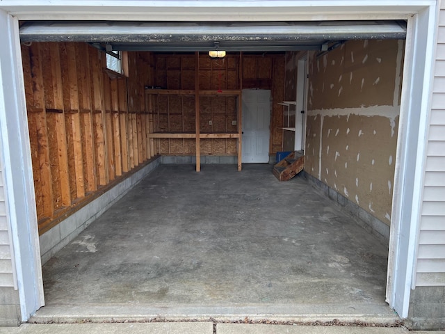 garage with a garage door opener and wood walls