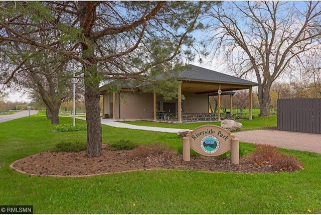 surrounding community featuring gravel driveway, a yard, and fence