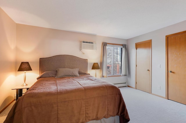 bedroom with carpet floors, a baseboard radiator, a wall mounted air conditioner, and baseboards