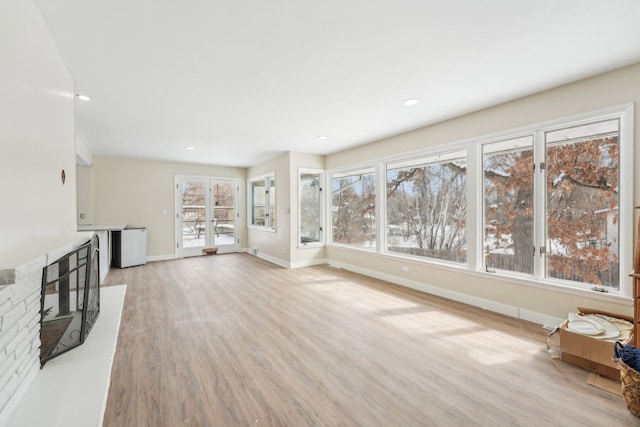 unfurnished living room featuring light wood-type flooring, baseboards, and recessed lighting