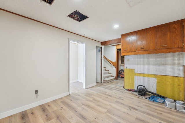 kitchen with light wood-style flooring, baseboards, and brown cabinets