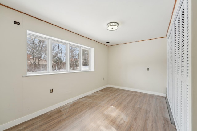 unfurnished bedroom with baseboards, a closet, visible vents, and light wood-style floors