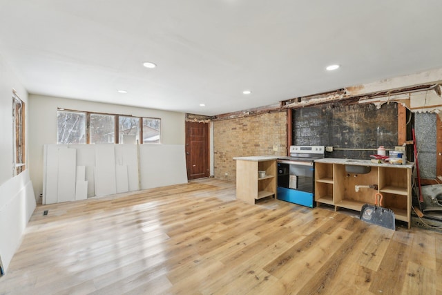 kitchen featuring open shelves, recessed lighting, brick wall, light wood-type flooring, and stainless steel electric range