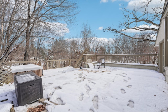 snowy yard with a wooden deck