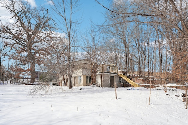 exterior space with a garage, stairway, and a wooden deck