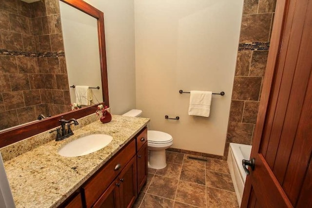 bathroom with toilet, vanity, baseboards, a tub, and walk in shower