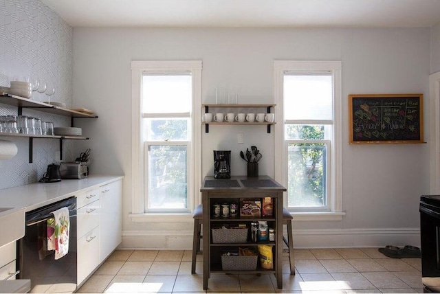 kitchen featuring black dishwasher, open shelves, and light tile patterned floors