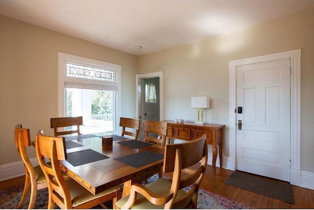 dining area featuring hardwood / wood-style flooring and baseboards